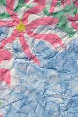 Pink flowers painted paints on a crumpled blue paper