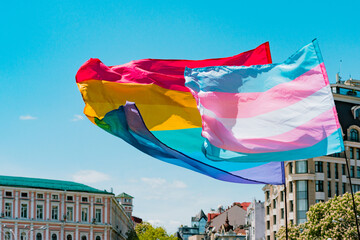 Waving transgender and gay rainbow LGBT flags. Pride. Gender. Intimacy. Transgender. Community. Relationship. Strike. Movement. Protest - obrazy, fototapety, plakaty