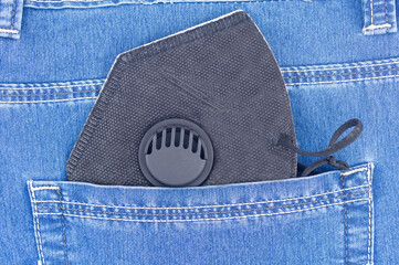medical face mask in blue jeans pocket
