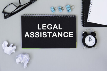 Legal assistance. informationon on a black notebook, on a background office table.