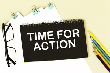 TIME FOR ACTION. informationon on a black notebook, on a background office table.