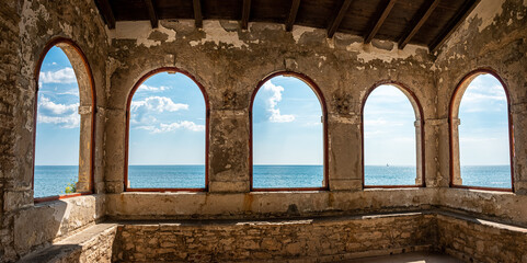 View through arcades of City Wall in Novigrad over adriatic Sea, Istria, croatia