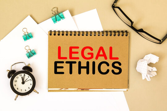 LEGAL ETHICS. TEXT on a notepad, on a desktop. Business, finance, image.