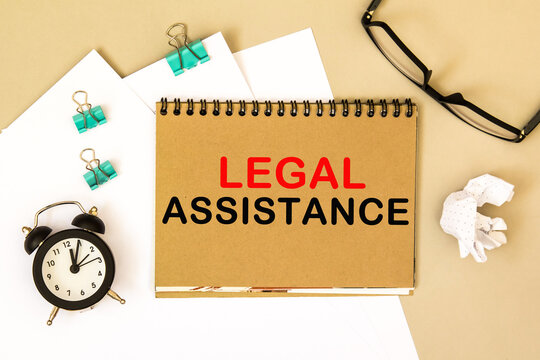 LEGAL ASSISTANCE. TEXT on a notepad, on a desktop. Business, finance, image.