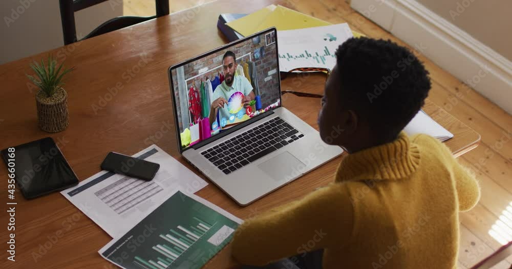 Sticker African american woman having a video call with male colleague on laptop at home