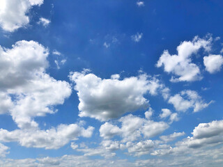 Naklejka na ściany i meble Dusk splash clouds against blue sky in sunshine day. Hazy sky.