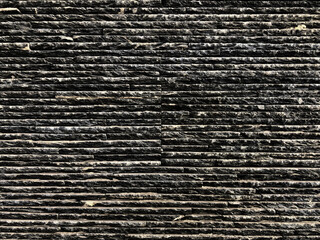 Pattern of dark tone stone wall texture. Rough natural texture background for art work or exterior concept idea.
