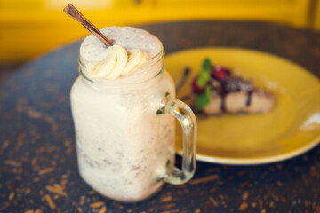 Smoothie and cheesecake with yellow background. Concept of healthy food. Healthy lifestyle and healthy eating concept.