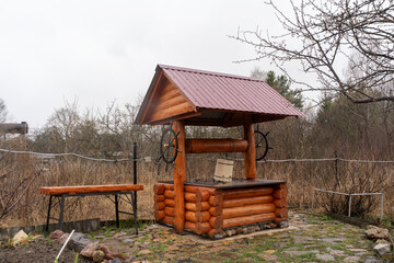 An old wooden well in the courtyard of a country house, a country plot, a Russian outback