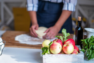 Female making dough. Dough, flour with accessories for the bakingin the composition on the kitchen table.