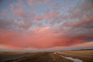 highway leading to orange sky at sunset