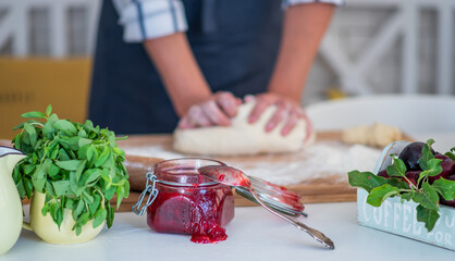 Female making dough. Dough, flour with accessories for the bakingin the composition on the kitchen table.