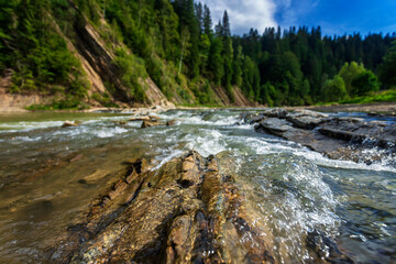 Mountain river rapids with shallow depth of field