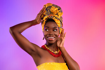 Photo of young afro american woman look empty space smile touch tribal clothes isolated on vibrant background - obrazy, fototapety, plakaty