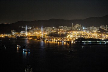Tsing Yi Hong Kong Stonecutters bridge at night cargo ship loading area