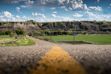 The centre line of paved country road along the South Saskatchewan river valley near Medicine Hat...