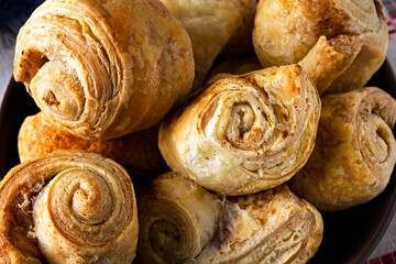Fresh homemade puff pastry rolls baked with cinnamon.