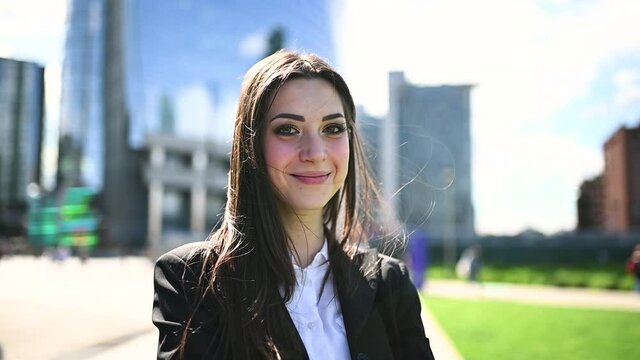 Beautiful businesswoman smiling in a windy day - slow motion