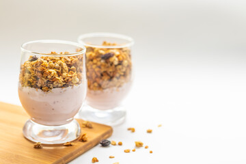 granola in a glass, muesli, healthy breakfast on a white plate