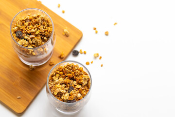 granola in a glass, muesli, healthy breakfast on a white plate