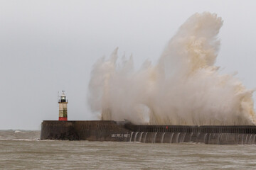 Waves crash against the Newhaven harbour wall during the morning high tide.