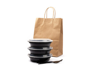 plastic food delivery containers beside a craft paper bag used by food delivery app companies isolated on white