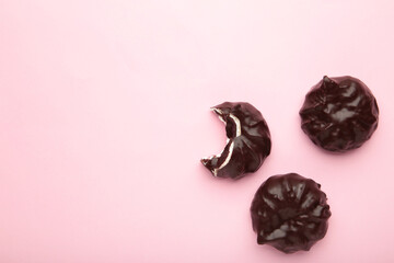 Chocolate covered marshmallows on pink background. Minimalism