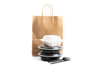 black and white food delivery containers with a kraft paper bag used by food delivery app companies isolated on white
