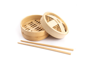 Asian or Chinese bamboo vegetable and dumpling steamer with chop sticks isolated on white
