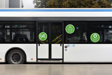 Electric city bus with zero emission at the stop in business downtown