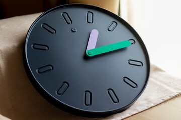 Close up shot of a clock with colorful hands.Indoors