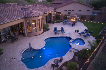 A high definition view of a desert landscaped backyard in Mesa Arizona, with a pool spa, outdoor...