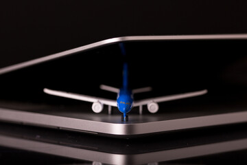 an aeroplane isolated inside a laptop on black background