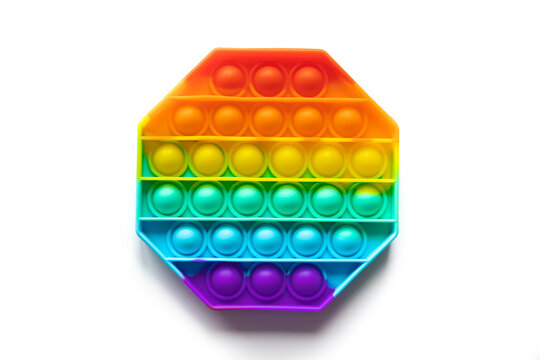 Pop It silicone sensory anti-stress Fidget kid toy colorful rainbow game isolated on white background, copy text space. Calming tools, adult stress reliever popping, trendy push bubble toys