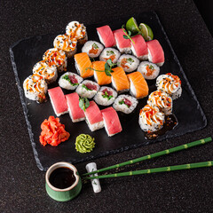 fresh and tasty sushi on the black background