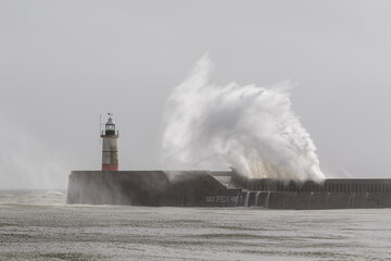 Waves pound Newhaven harbour entrance.