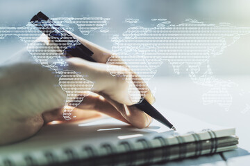 Abstract creative digital world map and woman hand writing in diary on background, globalization...