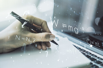 Creative scientific formula illustration with hand writing in diary on background with laptop,...