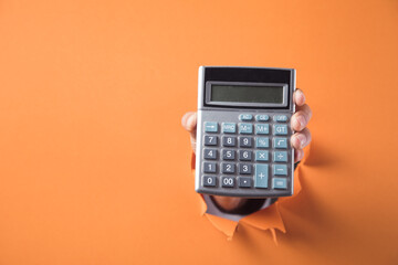 Hand holds calculator