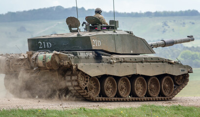 A British army Challenger 2 ii FV4034 Main Battle Tank travelling at speed in action on a military exercise, Wiltshire UK