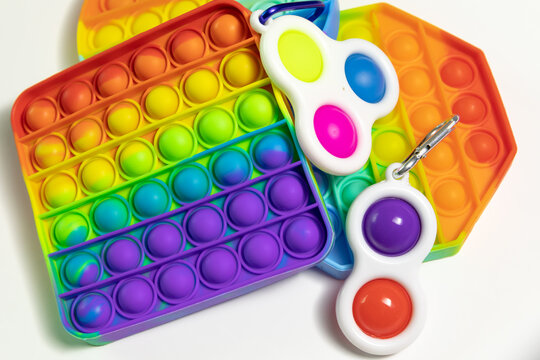 Pop It Simple Dimple - silicone sensory anti-stress Fidget toy colorful rainbow game isolated on white background, copy space. Calming tools, adult stress reliever popping, trendy push bubble toys