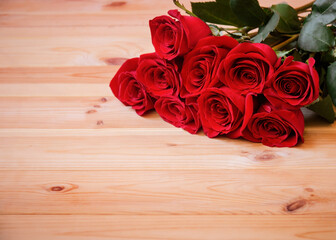Red roses on wooden table. Selective focus.