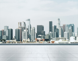 Empty concrete rooftop on the background of a beautiful Los Angeles city skyline at sunset, mock up