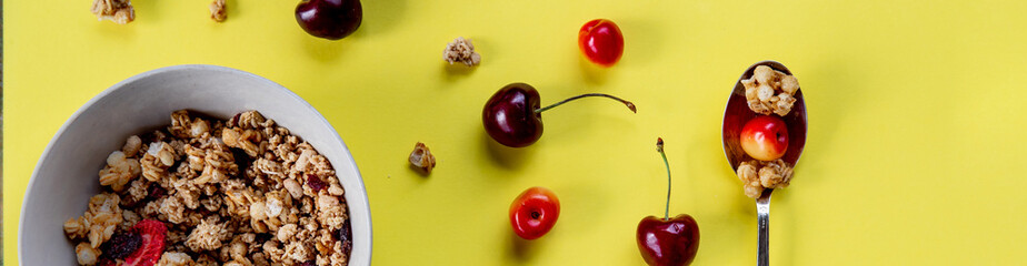 Multigrain wholewheat healthy cereals with fresh berry for breakfast overhead shot.Granola with yogurt and blueberry, cherries.Organic muesli with fresh fruits and yorgurt