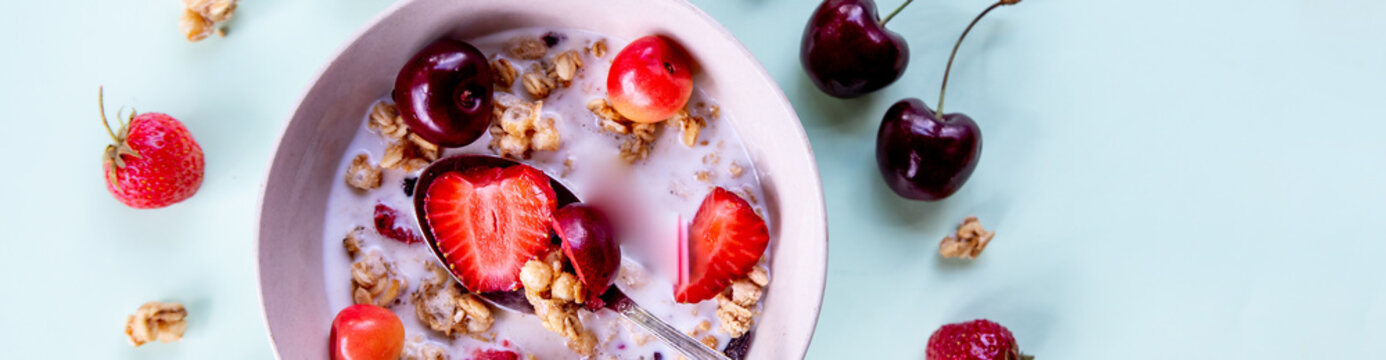 Multigrain wholewheat healthy cereals with fresh berry for breakfast overhead shot.Granola with yogurt and blueberry, cherries.Organic muesli with fresh fruits and yorgurt