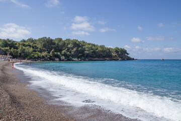 sea ​​surf waves and green peninsula