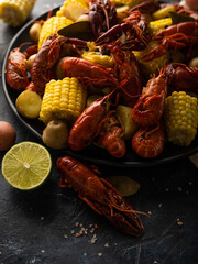 Bright colors of ingredients - boiled corn and boiled crayfish, yellow lemon create a very beautiful picture. Close-up. Macro photography.