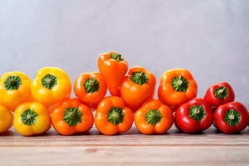 Close view of colorful orange, red and yellow peppers paprika background
