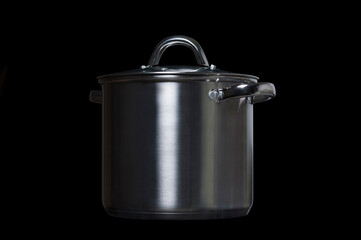 stainless steel pan on a black background