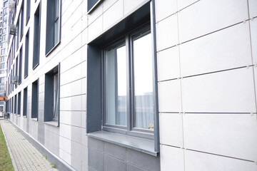 wall of office building made of metal plates with windows. Detail of modern residential building...